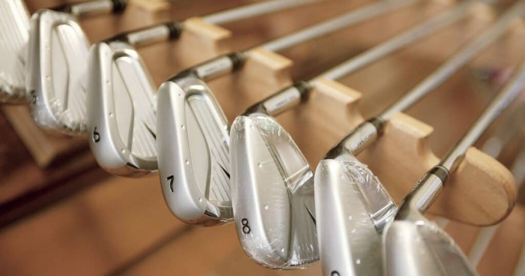 Golf clubs on a display rack in a golf shop